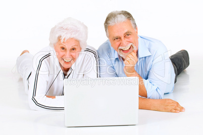 elderly couple using laptop