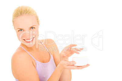 woman holding a jar of cream