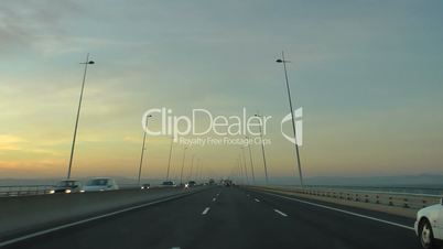 Driving  car in highway at sunset