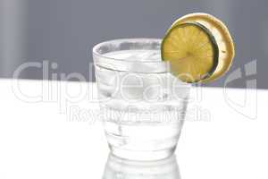 water with lemon and lime in a glass with ice