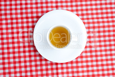 cup of tea on plaid fabric