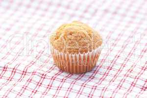 one muffin on plaid fabric