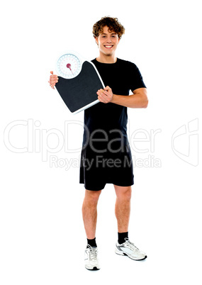 Handsome fit man holding weight machine