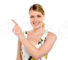 Happy young woman pointing copyspace
