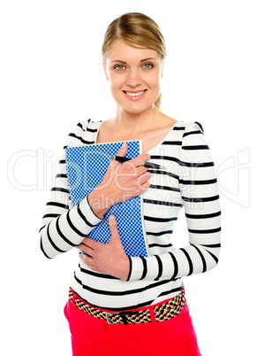 Smiling lady posing with pen and notepad