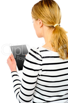 Rear view of teenage girl using touch screen device