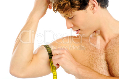 Handsome guy measuring his biceps