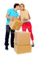 Young couple gently holding cartons