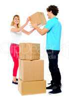 Couple carrying empty cartons