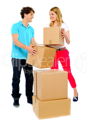 Couple carrying cardboard boxes