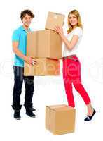 Lovely couple holding cardboard boxes