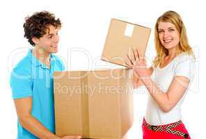 Couple arranging cardboard boxes