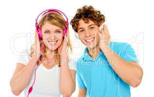 Couple enjoying music through headphones