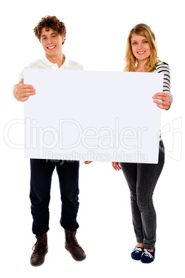 Adorable young couple promoting blank banner ad