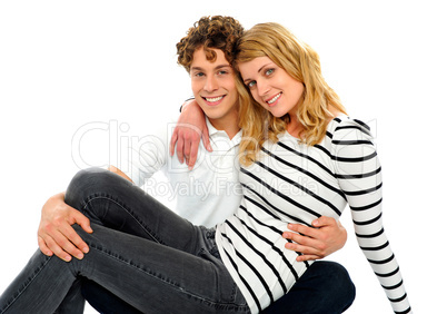 Female friend sitting on her boyfriends lap