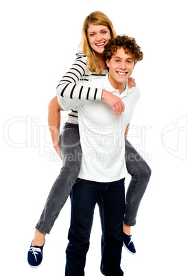 Boy piggybacks his girlfriend