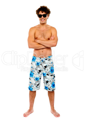 Beach guy posing shirtless, arms-crossed