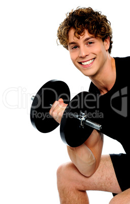 Strong young man working out with dumbbells