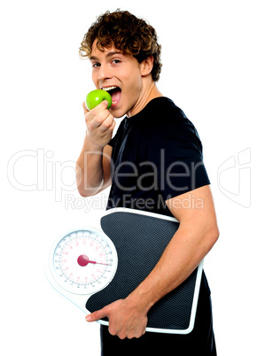 Smart boy eating green apple