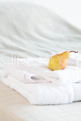 pear lying on towels on the bed