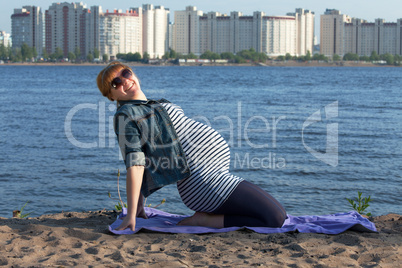 Pregnant woman doing gymnastic exercises