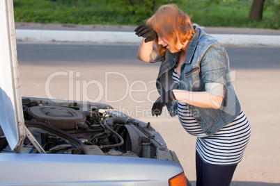 Pregnant Woman Trying to Repair the Car