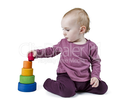 young child playing with colorful toy blocks