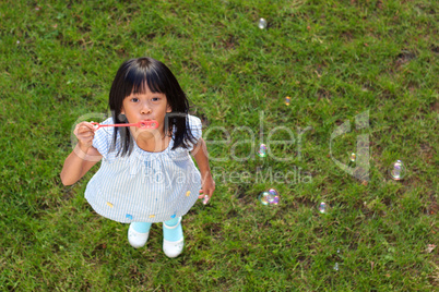 Little Asian Girl Blowing Bubbles