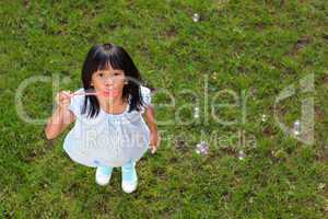Little Asian Girl Blowing Bubbles
