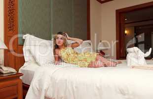 woman laiyng in hotel room bed