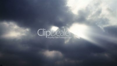 time lapse of the clouds billowing and moving with god rays