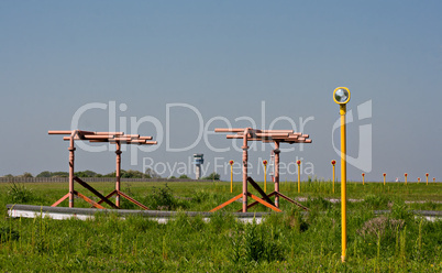 Airport landing lights with control tower in bacckground