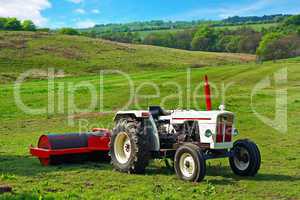 A white tractor in the fields