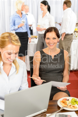 Business woman work during company buffet