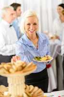 Smiling business woman during company lunch buffet