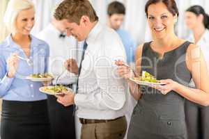 Smiling business woman during company lunch buffet