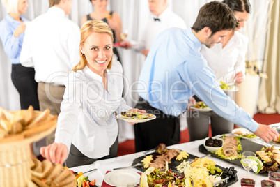 Business woman serve herself at buffet