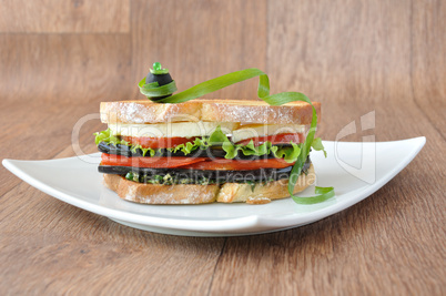 Sandwich with eggplant, tomatoes, peppers and cheese
