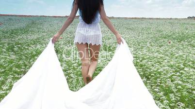 Young Woman With White Scarf In Field