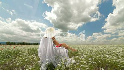 DOLLY:  Young Woman On White Field In Summer