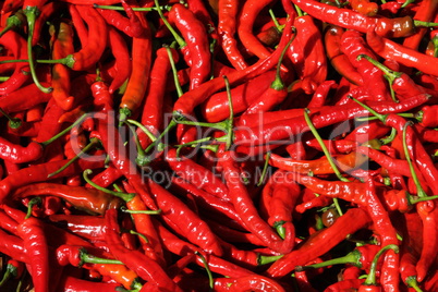 A basket full of fresh spicy chilli peppers in a Chinese market.