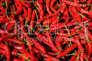 A basket full of fresh spicy chilli peppers in a Chinese market.