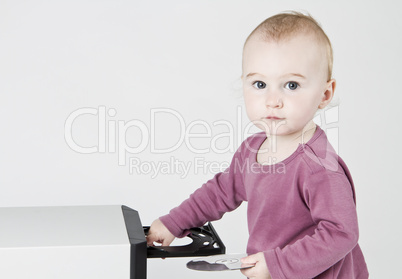 young child playing with CD