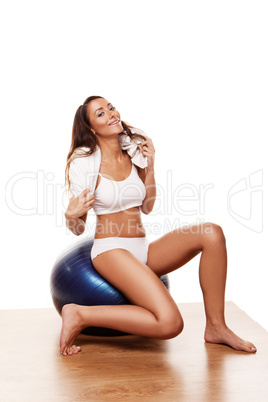 Sexy young female using a pilates ball and smiling