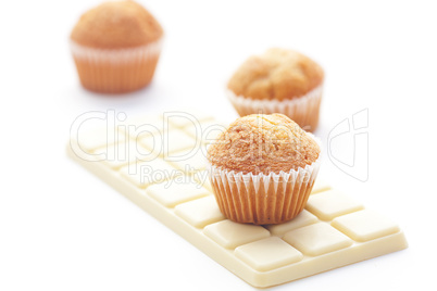 bar of white chocolate and muffin isolated on white