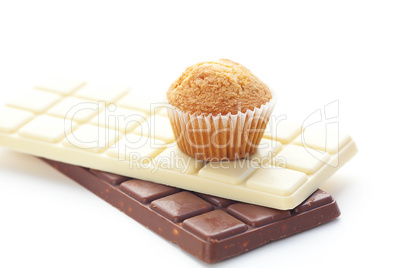 bar of chocolate and muffin isolated on white