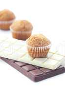 bar of chocolate and muffin isolated on white