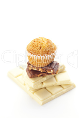 bar of chocolate and muffin isolated on white