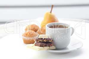 bar of chocolate,tea, muffin and pear