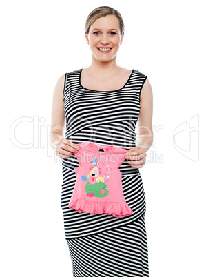 Young mum showing pink baby cloth to camera